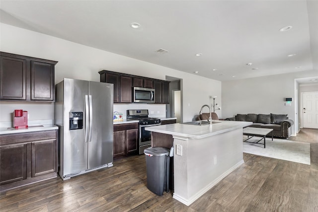 kitchen with dark wood-style floors, stainless steel appliances, a sink, and open floor plan