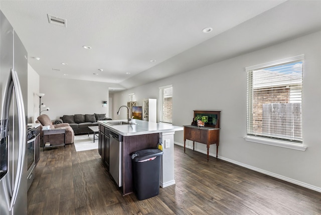 kitchen with open floor plan, a sink, visible vents, and dark wood-style floors