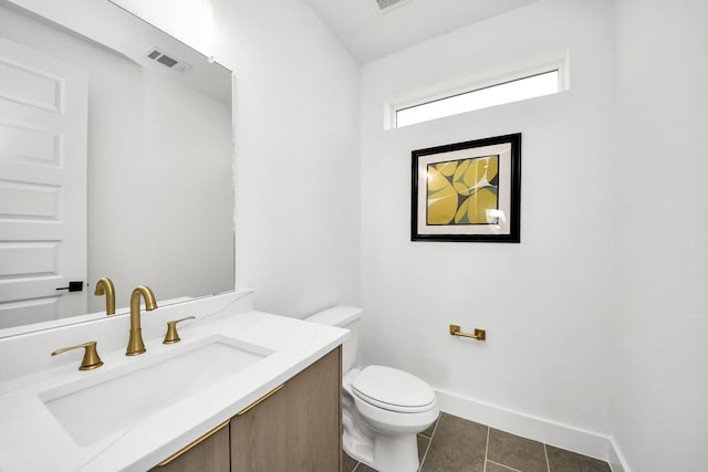 bathroom featuring tile patterned flooring, toilet, visible vents, vanity, and baseboards