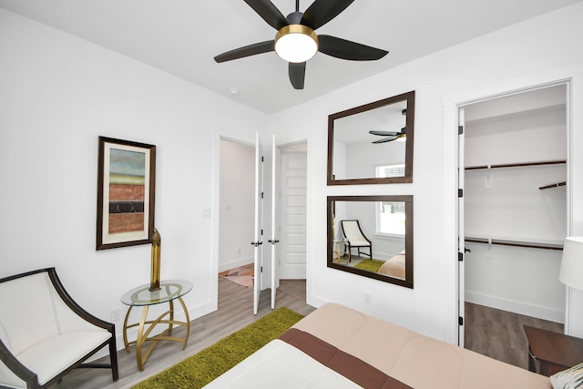 bedroom with a closet, baseboards, and wood finished floors