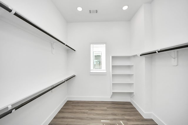 spacious closet with wood finished floors and visible vents