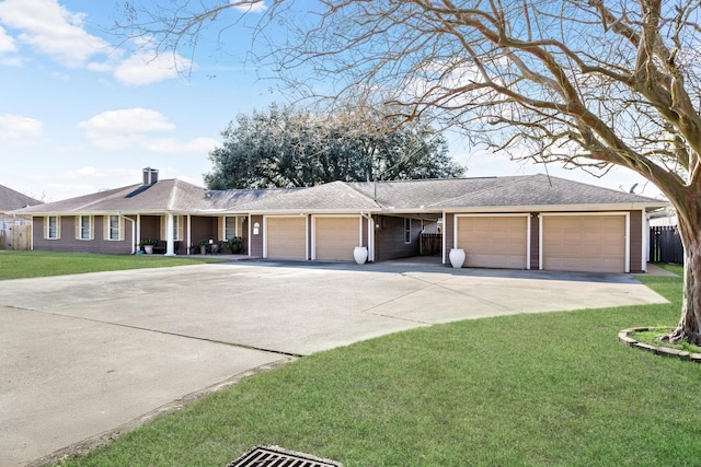 ranch-style home featuring a garage, roof with shingles, driveway, and a front lawn