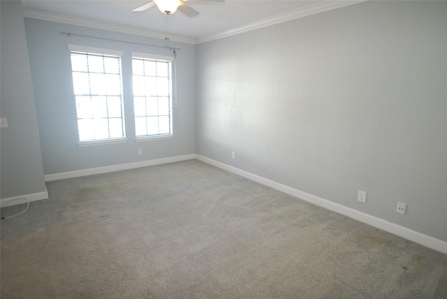 spare room featuring ceiling fan, baseboards, crown molding, and carpet flooring