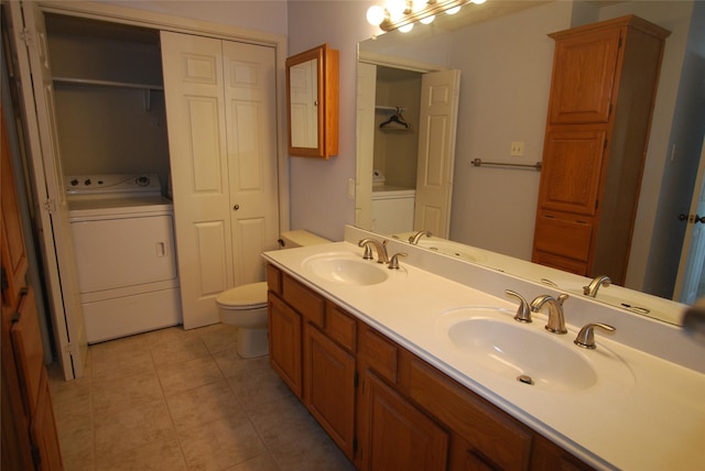 full bath featuring toilet, a closet, a sink, and washer / dryer