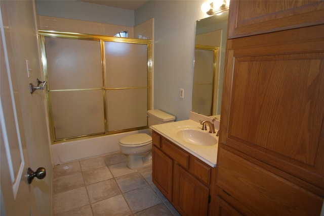 full bath featuring toilet, enclosed tub / shower combo, vanity, and tile patterned floors