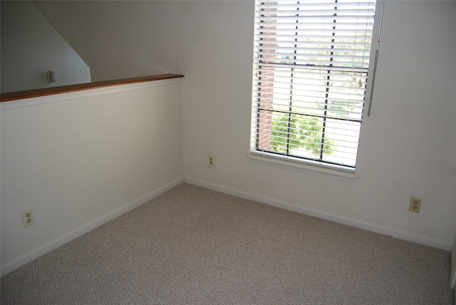 empty room with carpet and baseboards