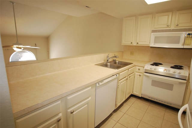 kitchen featuring white appliances, light tile patterned floors, light countertops, and a sink