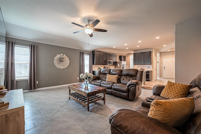 living area with light tile patterned floors, baseboards, a ceiling fan, and recessed lighting