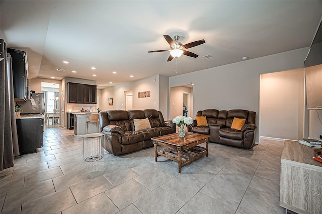 living room with light tile patterned floors, visible vents, a ceiling fan, and recessed lighting