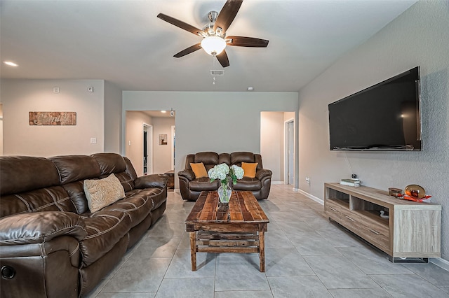 living room with ceiling fan, light tile patterned flooring, visible vents, and baseboards