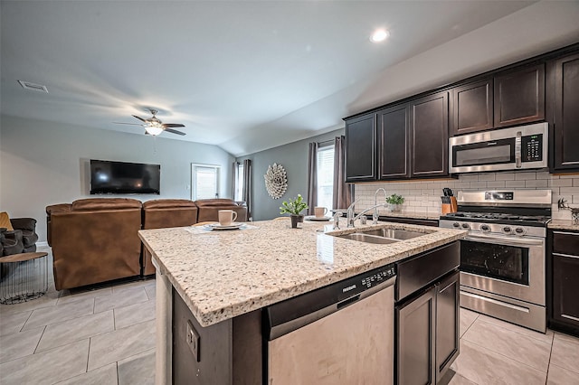 kitchen with light tile patterned floors, tasteful backsplash, visible vents, appliances with stainless steel finishes, and a sink