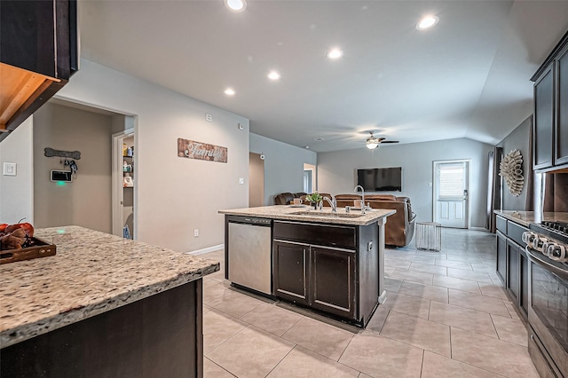 kitchen featuring stainless steel appliances, a ceiling fan, open floor plan, a sink, and an island with sink