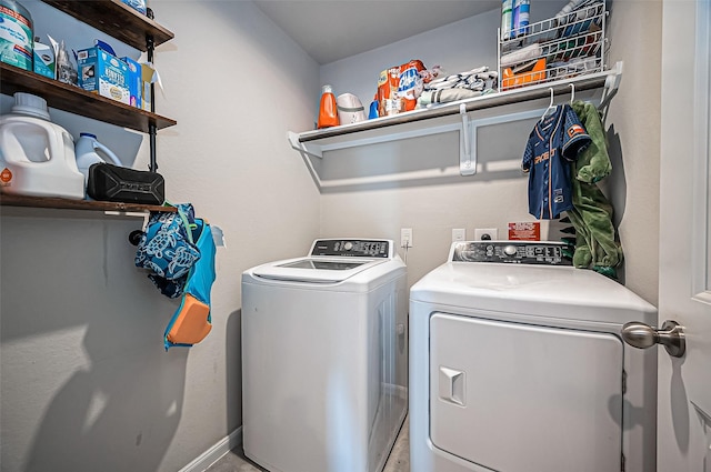 clothes washing area featuring laundry area and washer and dryer