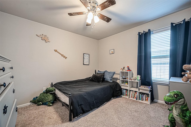 carpeted bedroom with a ceiling fan and baseboards