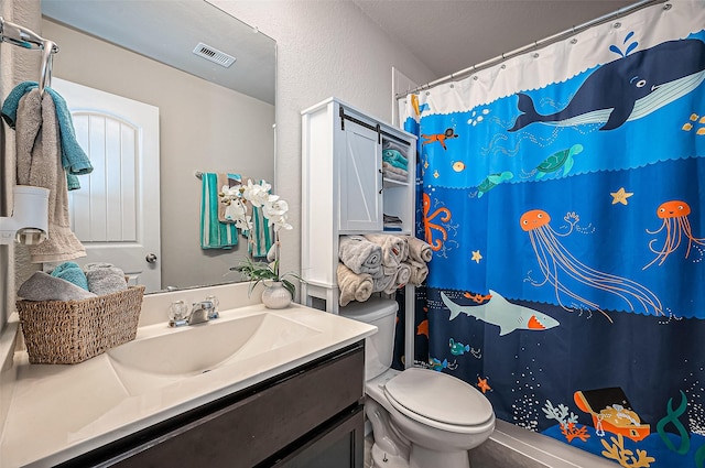 bathroom with visible vents, a textured wall, a shower with shower curtain, toilet, and vanity