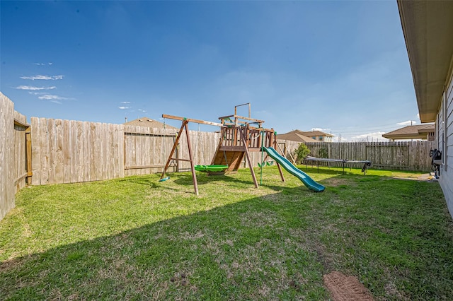 view of jungle gym featuring a fenced backyard, a trampoline, and a yard