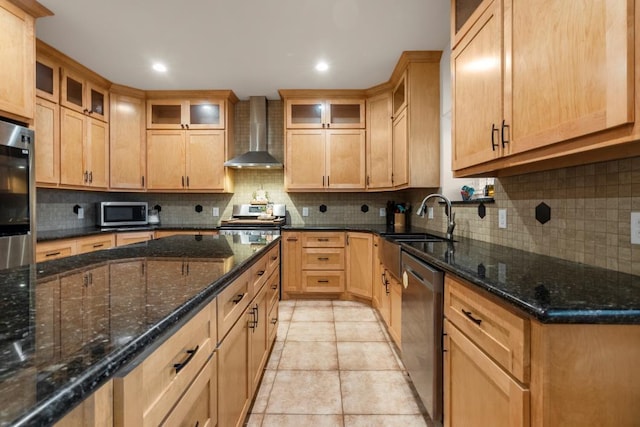 kitchen with light tile patterned flooring, appliances with stainless steel finishes, wall chimney exhaust hood, tasteful backsplash, and dark stone countertops