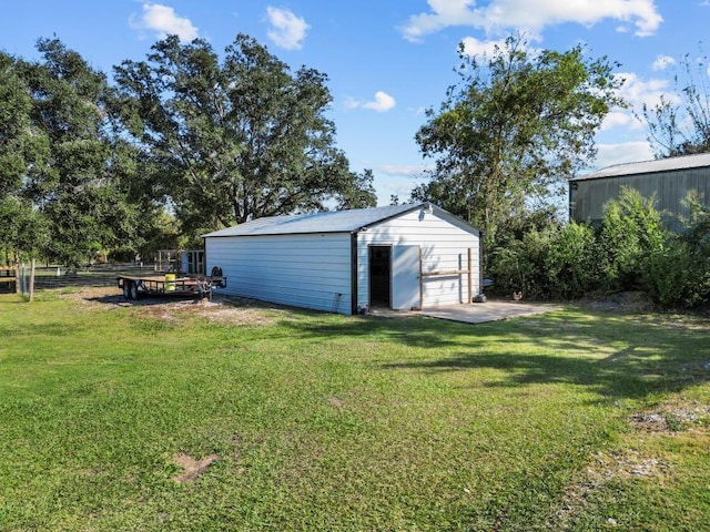 view of yard featuring a garage and an outdoor structure