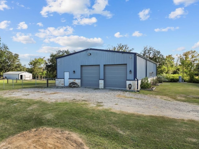 detached garage featuring fence