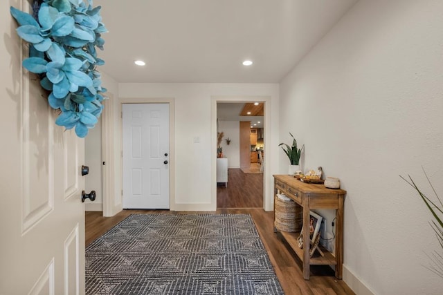 doorway to outside with recessed lighting, baseboards, and wood finished floors