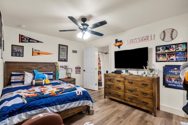 bedroom featuring baseboards, a ceiling fan, and wood finished floors