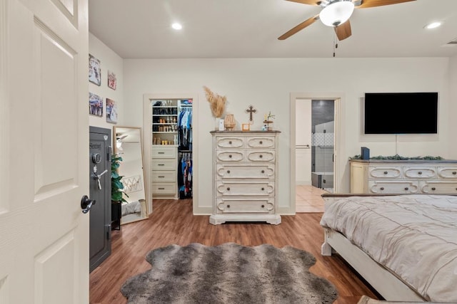 bedroom featuring recessed lighting, a closet, a spacious closet, light wood-style floors, and connected bathroom