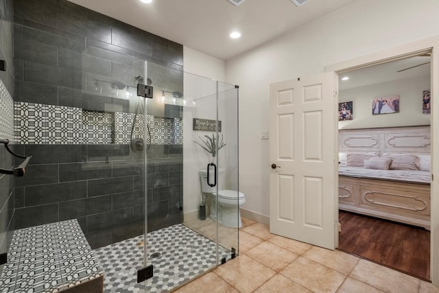 bathroom featuring recessed lighting, a shower stall, baseboards, and tile patterned floors