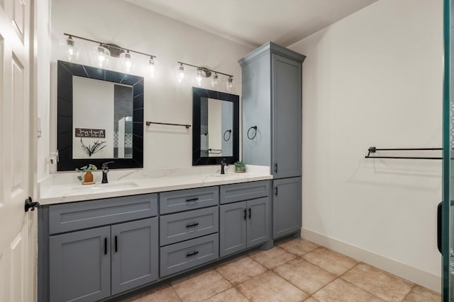 full bathroom featuring double vanity, tile patterned flooring, baseboards, and a sink