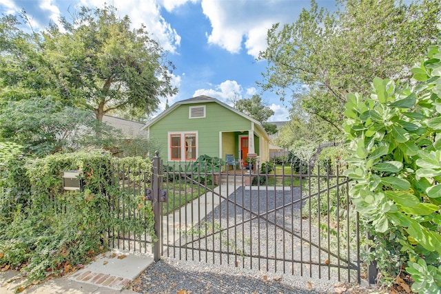 bungalow-style house featuring a fenced front yard and a gate