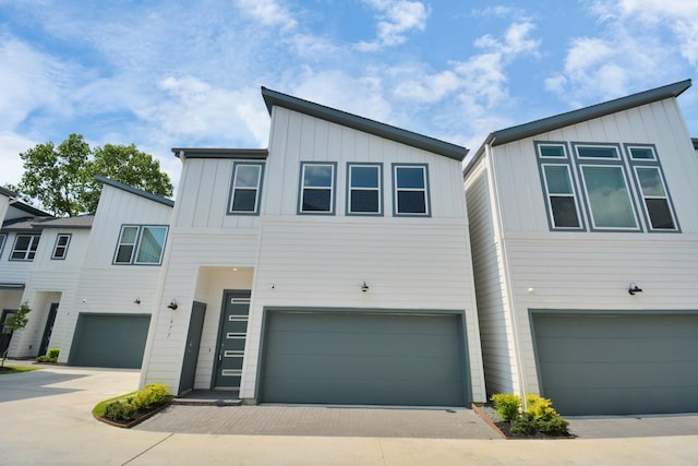 view of front of home with driveway, board and batten siding, and an attached garage