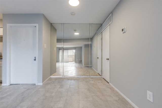 hallway featuring baseboards