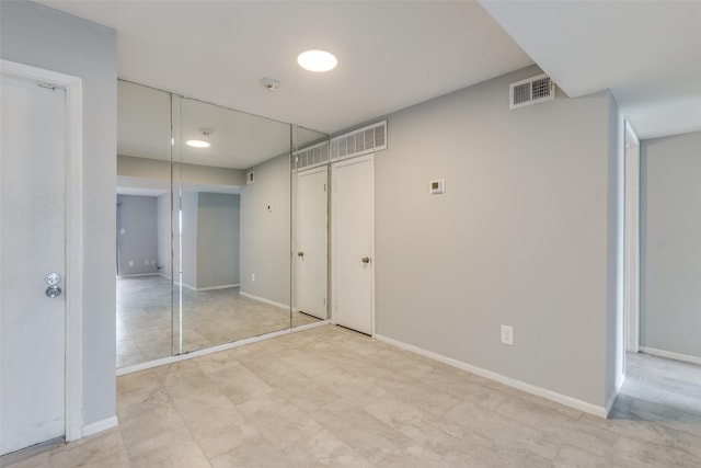 unfurnished bedroom featuring baseboards and visible vents