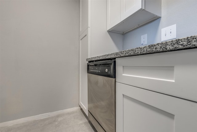 kitchen with baseboards, white cabinets, and dishwasher