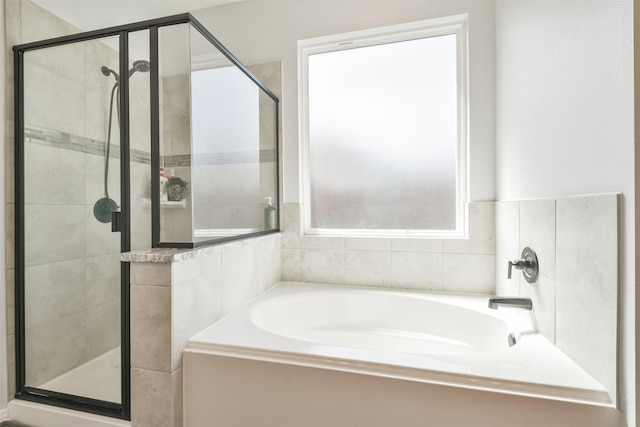 bathroom with a garden tub and a shower stall