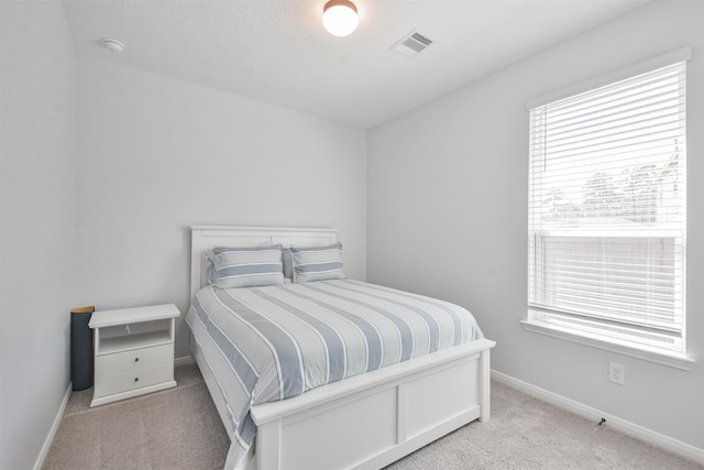 bedroom featuring baseboards, visible vents, and carpet flooring