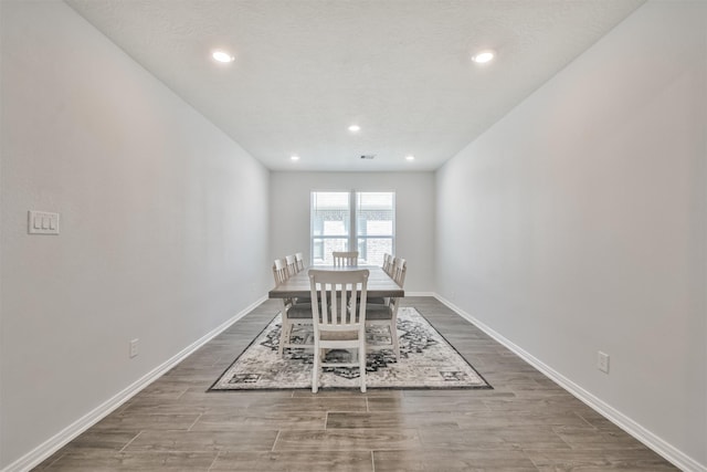 unfurnished dining area with recessed lighting, wood finished floors, and baseboards