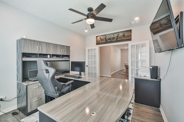 office space featuring ceiling fan, recessed lighting, wood finished floors, baseboards, and french doors