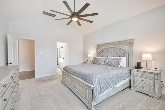 bedroom featuring ceiling fan, high vaulted ceiling, light colored carpet, baseboards, and ensuite bath