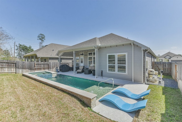 back of house featuring a patio, a fenced backyard, roof with shingles, a yard, and a pool with connected hot tub