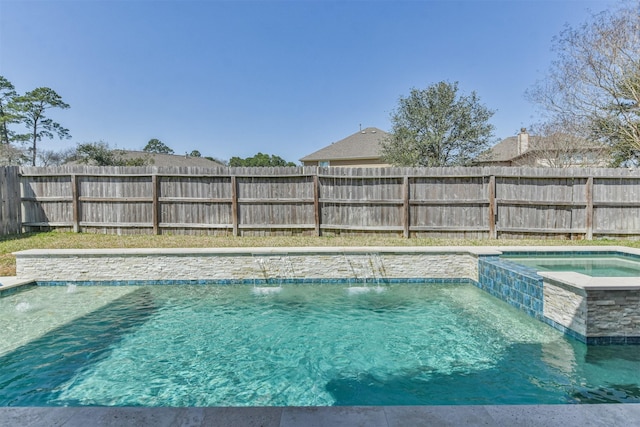 view of pool featuring a fenced backyard and a pool with connected hot tub