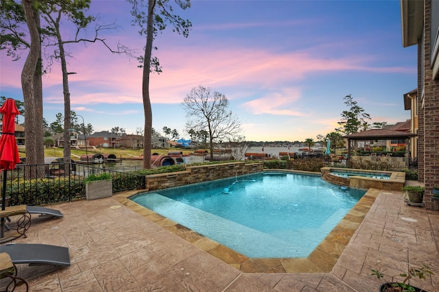 view of pool featuring a patio and a pool with connected hot tub