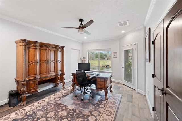 home office with ornamental molding, baseboards, visible vents, and light wood finished floors