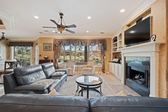 living room with built in features, visible vents, a fireplace with flush hearth, ornamental molding, and ceiling fan