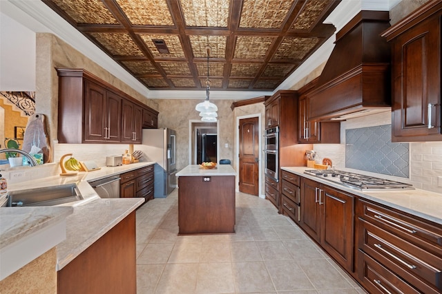 kitchen with stainless steel appliances, a kitchen island, a sink, decorative backsplash, and an ornate ceiling