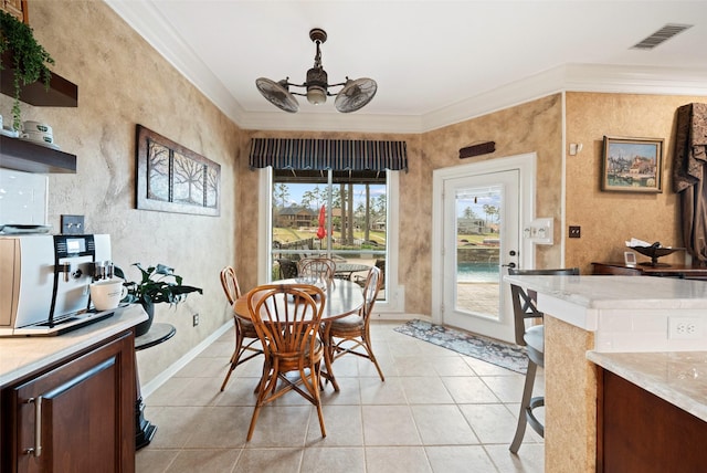 dining room featuring ornamental molding, visible vents, baseboards, and light tile patterned flooring