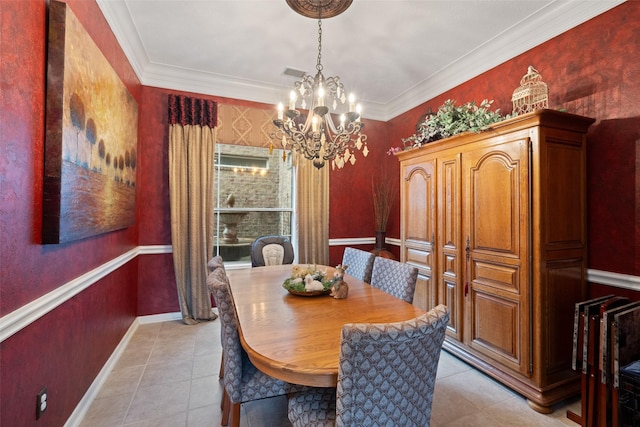 dining room featuring an inviting chandelier, visible vents, crown molding, and wainscoting