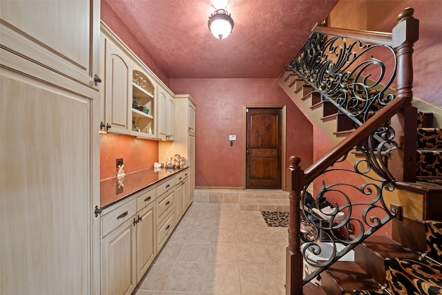 wine cellar featuring light tile patterned floors and a textured ceiling