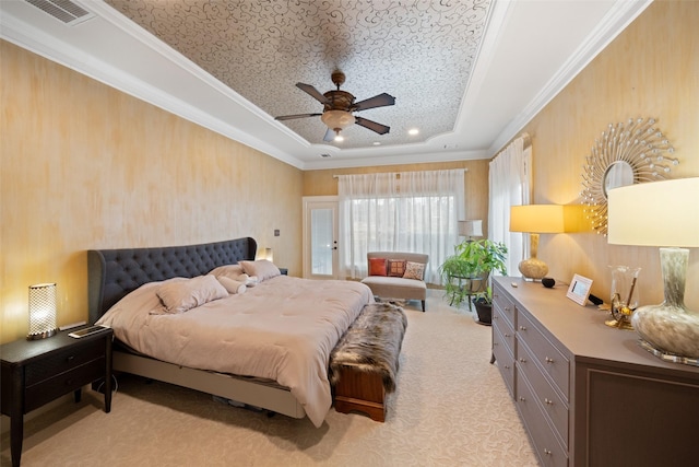 bedroom with light carpet, visible vents, a raised ceiling, and crown molding