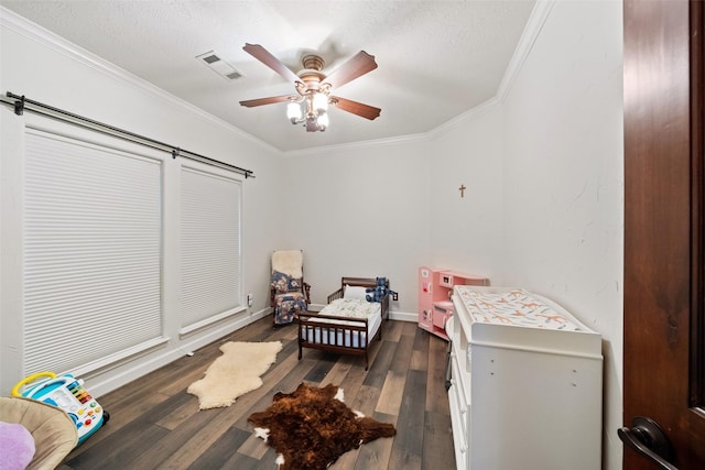 bedroom featuring dark wood-style floors, ornamental molding, a textured ceiling, and visible vents