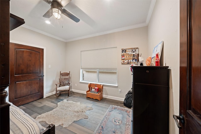 bedroom featuring a ceiling fan, baseboards, ornamental molding, and wood finished floors